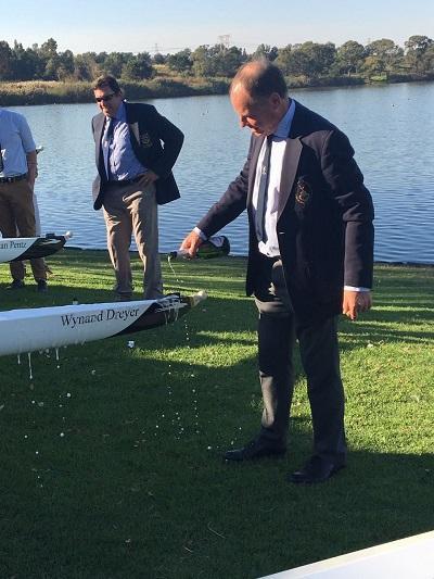 Wynand Dreyer pours champagne on the new WUBC boat named after him